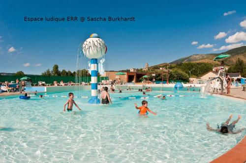 a group of people swimming in a swimming pool at Camping Las Asperas*** in Palau-de-Cerdagne