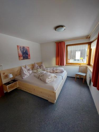 a bedroom with a large bed in a room at Ferienhof PUA in Sent