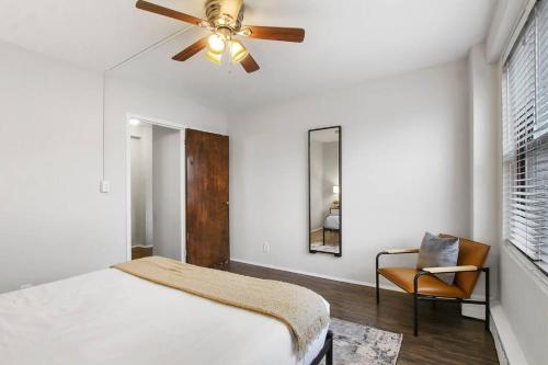 a bedroom with a ceiling fan and a chair at Chic & Cozy 1BR Apt in Chicago - Hyde Park 408 in Chicago