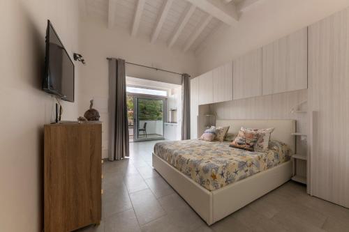 a bedroom with a bed and a flat screen tv at ***Villa Prestige**** in Capoliveri