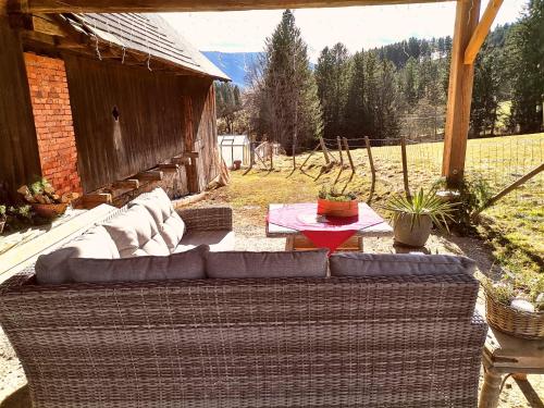 a couch sitting on a patio in front of a building at Landhaus Schusterfranz in Oberneudorf