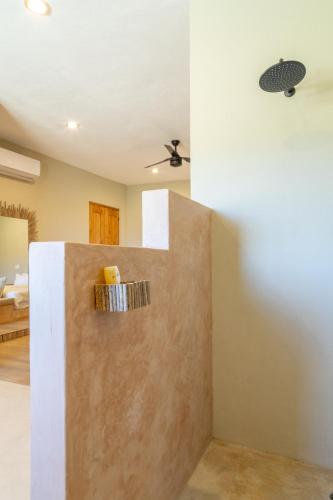 a bathroom with a wall with a towel rack at Cerritos Surf Town - Beach Front Property in El Pescadero