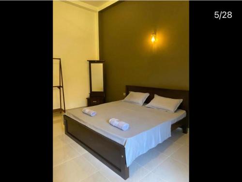 a bedroom with a bed with two pillows on it at Negombo 146 Homestay in Negombo