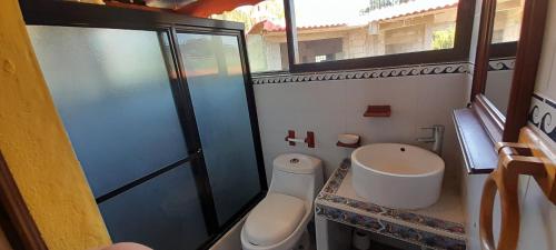 a bathroom with a toilet and a sink at San Ignacio zona 7 in Mixco