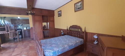sypialnia z łóżkiem z drewnianą ramą w obiekcie San Ignacio zona 7 w mieście Mixco