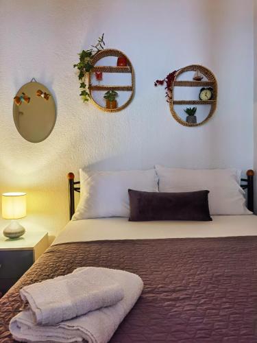 a bedroom with a bed with mirrors on the wall at Sailor's Delight in Kavala