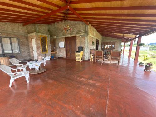 a large living room with wooden floors and chairs at Casa Campestre Lago Calima in Calima