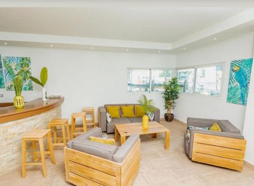 a living room with couches and tables and chairs at Hotel bienvenida in Los Tres Brazos