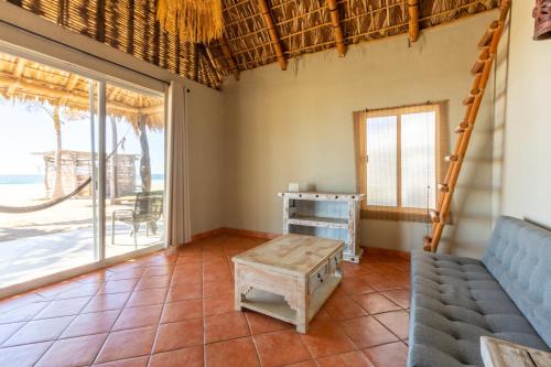 a living room with a couch and a table at Cerritos Surf Town - Beach Front Property in El Pescadero
