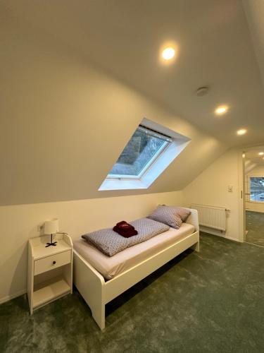 a bedroom with a bed and a window on the ceiling at Relaxen im Weindorf Mayschoß Fewo 4 in Mayschoß