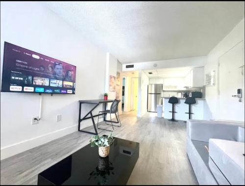 a living room with a large screen on the wall at Miami International Airport 2 in Miami