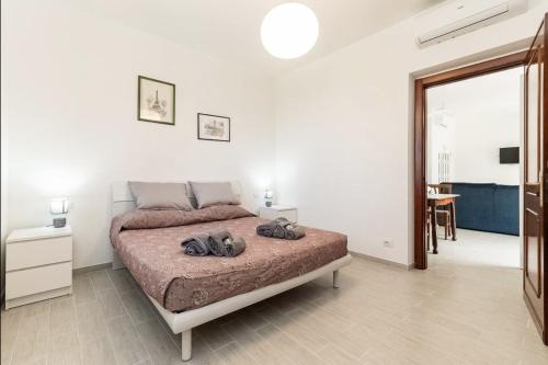 a bedroom with a bed in a white room at Oasi di Pace Sarzana in Luni