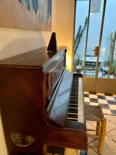 a piano sitting next to a room with a window at Riad Dar-tus in Tangier