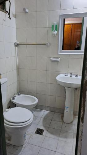 a bathroom with a toilet and a sink at Delfina -Catamarca, Zona Centro in San Fernando del Valle de Catamarca