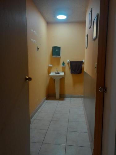 a bathroom with a sink and a mirror and a toilet at Casa de Ana in Tijuana