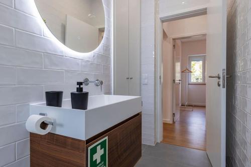 a bathroom with a white sink and a mirror at Charming Alvalade, in prestigious area of Lisboa. in Lisbon