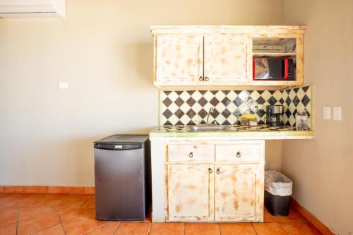a small kitchen with a counter and a microwave at Cerritos Surf Town - Beach Front Property in El Pescadero