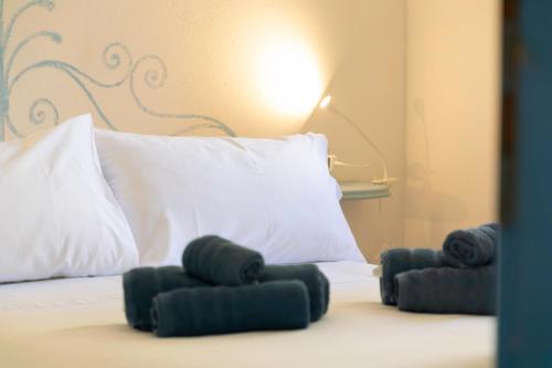 a white bed with two pillows on top of it at La Vela Summer House - FREE WIFI - 700mt from the beach in Costa Rei
