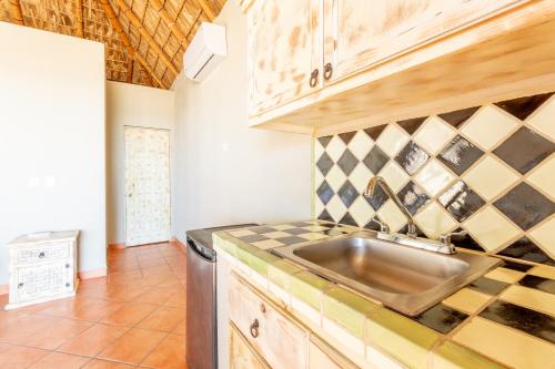 a kitchen with a sink and a counter top at Cerritos Surf Town - Beach Front Property in El Pescadero