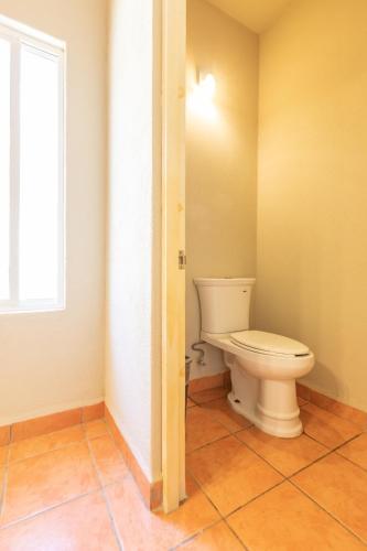 a bathroom with a white toilet in a room at Cerritos Surf Town - Beach Front Property in El Pescadero