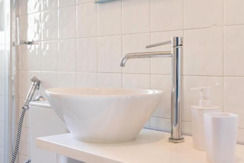 a white sink sitting on a counter in a bathroom at La Vela Summer House - FREE WIFI - 700mt from the beach in Costa Rei