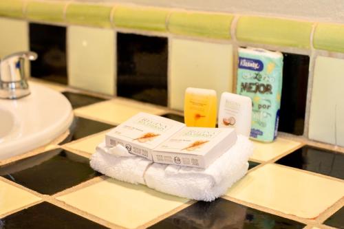 a pile of toiletries on a counter in a bathroom at Cerritos Surf Town - Beach Front Property in El Pescadero