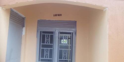 a door in a building with a sign above it at Lukwanga avenue air B&B in Kampala