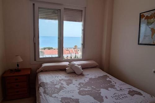 um quarto com uma cama e uma janela em Seaview Penthouse Magnificó Ático Duplex con vistas al mar em Manilva