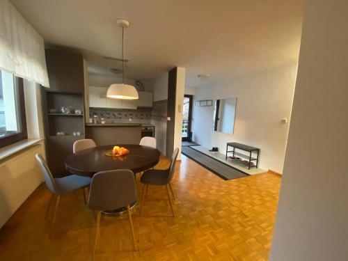 a dining room and living room with a table and chairs at Spacious Haven with Homey Vibes near Ljubljana in Horjul