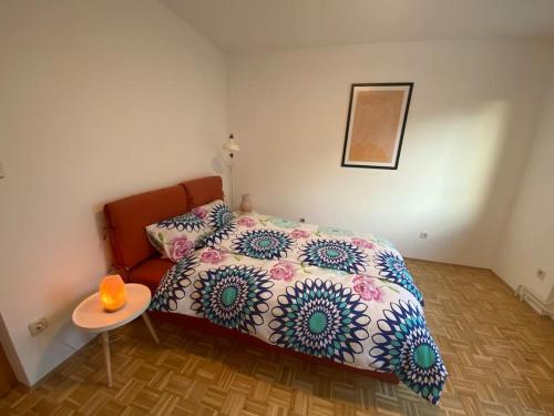 a small bedroom with a bed and a table at Spacious Haven with Homey Vibes near Ljubljana in Horjul