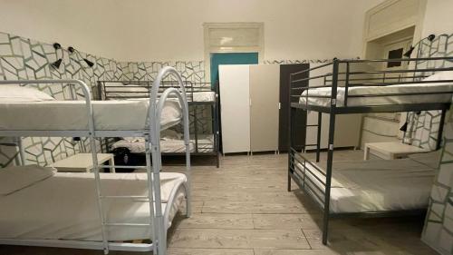 a room with several bunk beds and a hallway at Balarm - Hostel and Bar in Palermo
