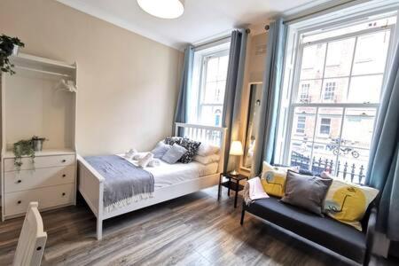 a bedroom with a bed and a large window at Cosy Central Studio off OConnell FAST WIFI in Dublin