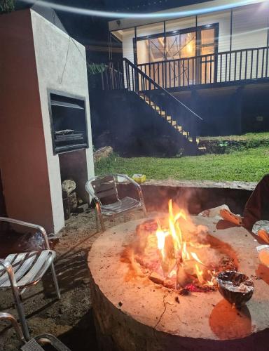 a fire pit in a yard next to a house at Le Bamboo Guest House And Boat Cruise in Hartbeespoort