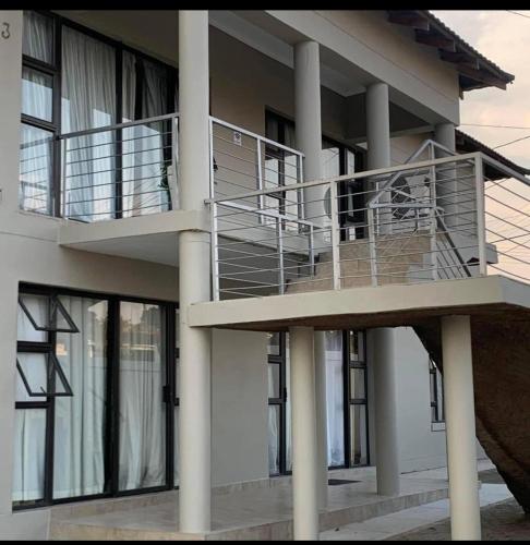 a building with a balcony with a staircase at GoldenWays Apartment 3 in Mbabane