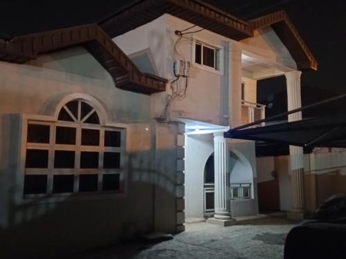 a house lit up at night with a flashlight at Treasure Apartment in Lagos