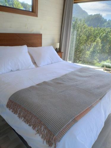 Una cama o camas en una habitación de tiny house comuy