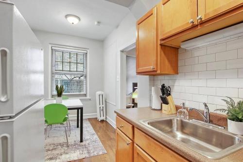 a kitchen with a sink and a table at Chicago Studio Unit Cozy & Convenient - BStone 226 rep in Chicago