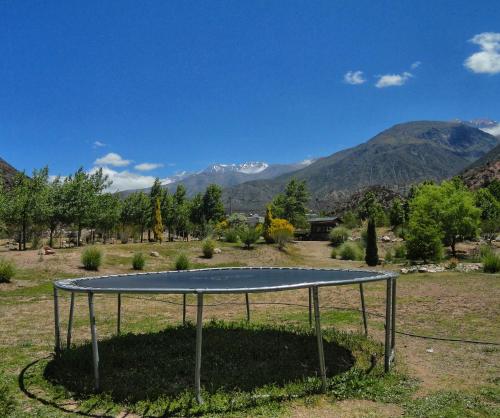 a tennis court in a field with mountains in the background at Viví Potrerillos in Potrerillos