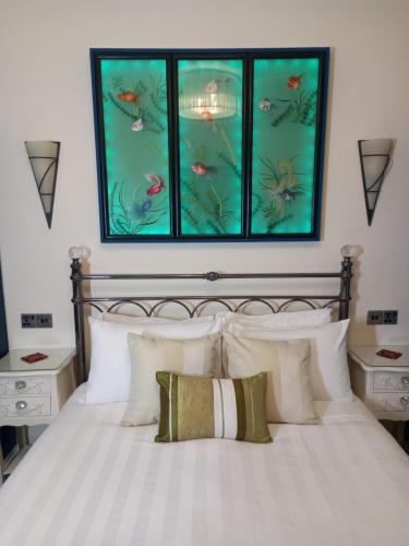 a bedroom with a bed with a fish painting above it at The Gatsby Blackpool - Formerly The Windsor in Blackpool