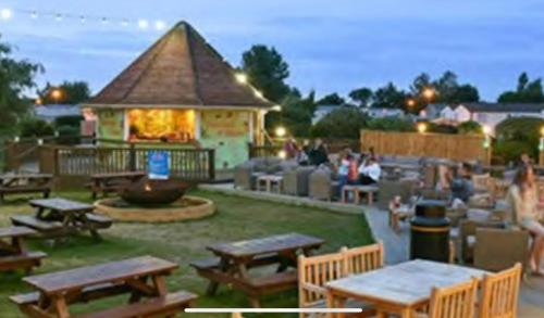 a group of picnic tables in front of a building at Morning side in Skegness
