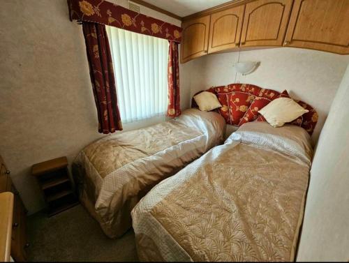 a bedroom with two beds and a window at Morning side in Skegness