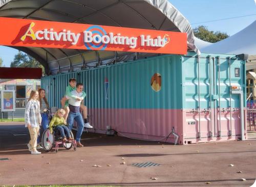 a group of people standing outside of a play building at Morning side in Skegness