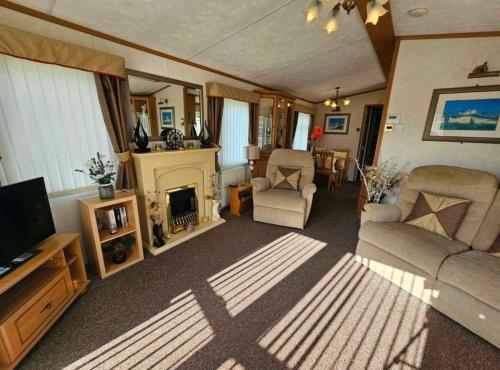 a living room with a couch and a fireplace at Morning side in Skegness