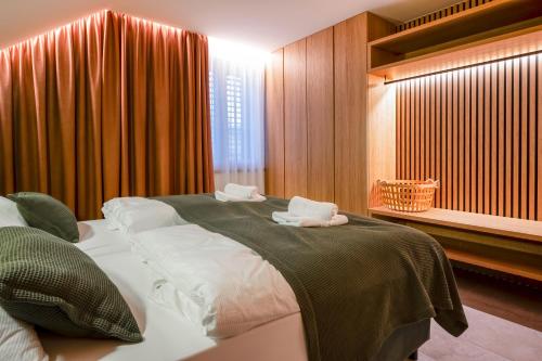 a bedroom with a large bed with towels on it at Residence Smržovka - Luxury House with Swimming Pool, Jacuzzi, Garden and BBQ in Jablonec nad Nisou