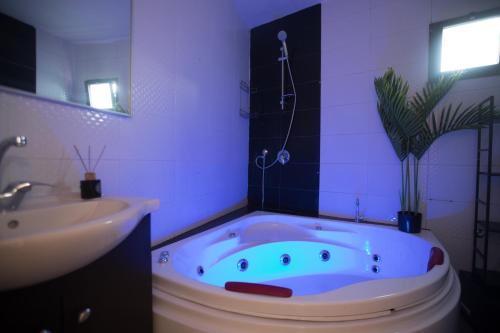 a bathroom with a bath tub and a sink at Sweet Dreams Apartment in Tiberias