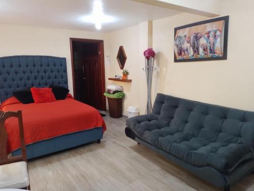 a living room with a couch and a bed at Mi Pueblito Magico in El Oro de Hidalgo