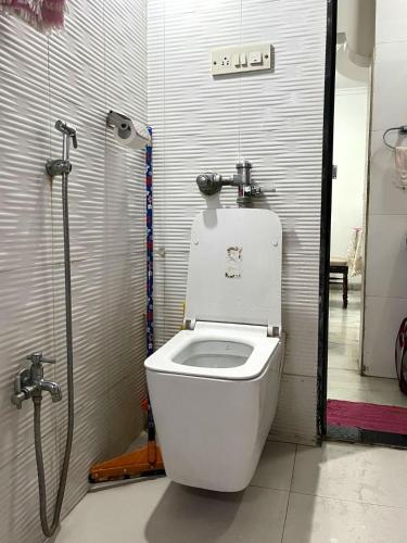 a bathroom with a toilet in a stall at Calm Private Room with Beautiful View in Mumbai