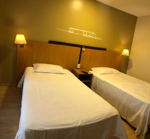 a hotel room with two beds in a room at Flat 609 - Comfort Hotel Taguatinga in Brasilia