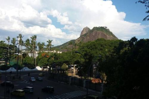 里約熱內盧的住宿－Apartamento Morro Da Urca，享有高山美景,设有停放在街道上的汽车
