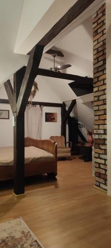 a living room with a bed and a ceiling at LAZARÓWKA - RYBNO in Rybno